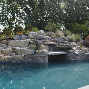 Custom Freeform style salt water in ground pool with Waterslide and Spa