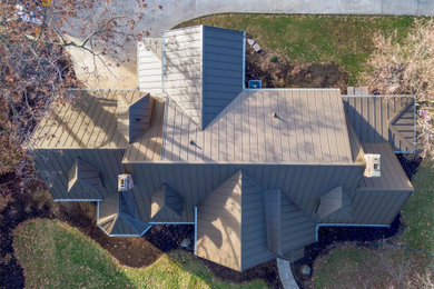 Elegant two-story exterior home photo in Other with a metal roof and a gray roof