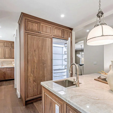 Seamless Flow – Natural Stone Meets Rich Walnut Cabinetry