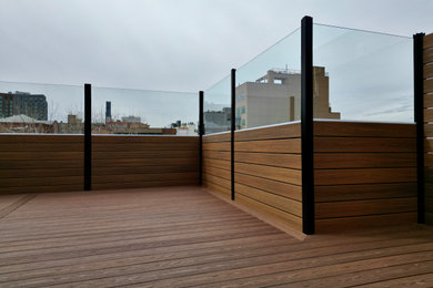 Mid-sized urban rooftop rooftop privacy and mixed material railing deck photo in New York with no cover