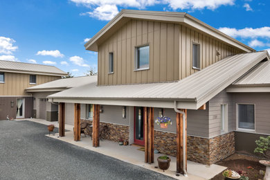 Inspiration for a huge rustic gray one-story mixed siding exterior home remodel in Seattle with a metal roof