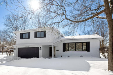 Elegant white brick and board and batten house exterior photo in Chicago