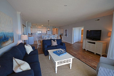 Living room - coastal open concept light wood floor living room idea in Charleston
