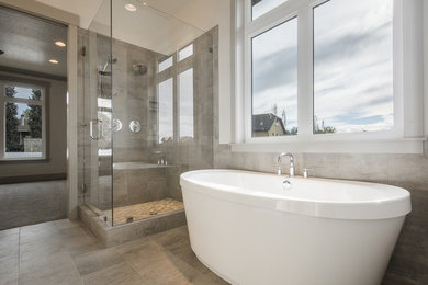 Freestanding bathtub - master gray tile and ceramic tile ceramic tile and gray floor freestanding bathtub idea in Salt Lake City with shaker cabinets, medium tone wood cabinets, white walls, an undermount sink and quartz countertops
