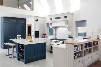 Mid-sized transitional l-shaped open plan kitchen in Other with grey floor.