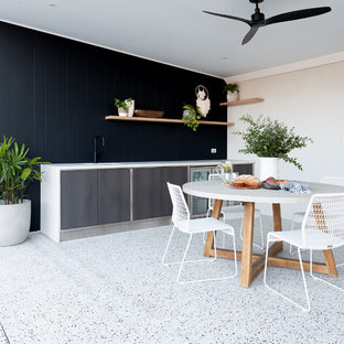 Photo of a mid-sized contemporary backyard patio in Perth with a roof extension.