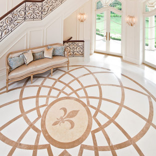 Выдающиеся фото от архитекторов и дизайнеров интерьера: огромное фойе в классическом стиле с бежевыми стенами, мраморным полом и двустворчатой входной дверью