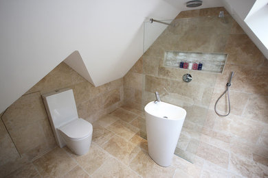 Mid-sized contemporary master wet room bathroom in Surrey with a corner tub, a two-piece toilet, beige tile, stone tile, beige walls, travertine floors and beige floor.