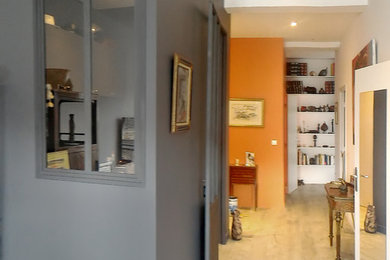 Design ideas for a mid-sized eclectic foyer in Other with orange walls, ceramic floors and beige floor.