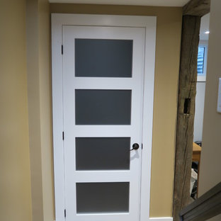 Design ideas for a large classic fully buried basement in Ottawa with yellow walls, light hardwood flooring, no fireplace and beige floors.