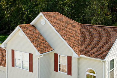 Inspiration for a mid-sized timeless beige two-story vinyl gable roof remodel in Tampa