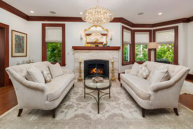 Mid-sized transitional formal enclosed living room in Seattle with white walls, dark hardwood floors, a standard fireplace, a stone fireplace surround and brown floor.