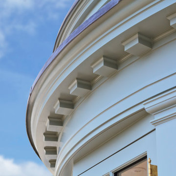 Curved orangery makes the most of an unused corner courtyard