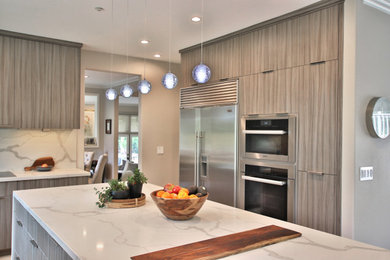 Large trendy u-shaped light wood floor and beige floor open concept kitchen photo in San Francisco with a single-bowl sink, flat-panel cabinets, gray cabinets, quartz countertops, white backsplash, quartz backsplash, stainless steel appliances, an island and white countertops