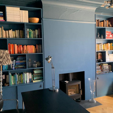 Bookcase on each side of chimney breast with sliding doors