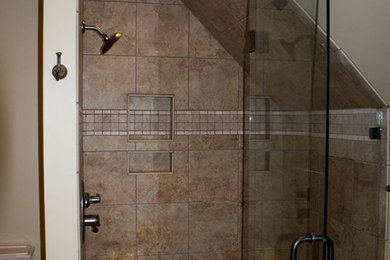 Example of a mid-sized classic master brown tile and porcelain tile mosaic tile floor alcove shower design in Other