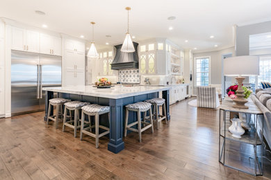 Kitchen - large kitchen idea in DC Metro with white cabinets, multicolored backsplash, stainless steel appliances, an island and white countertops
