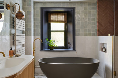 Traditional bathroom in Other with medium wood cabinets, a freestanding bath, blue tiles, white walls, an integrated sink, white floors, white worktops, a single sink and a floating vanity unit.