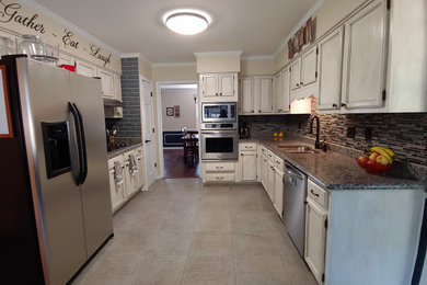 Inspiration for a mid-sized country galley ceramic tile and gray floor enclosed kitchen remodel in Other with a double-bowl sink, recessed-panel cabinets, distressed cabinets, granite countertops, multicolored backsplash, mosaic tile backsplash, stainless steel appliances, no island and gray countertops