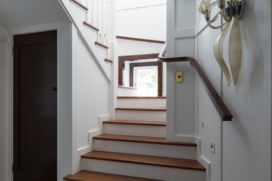 Design ideas for a mid-sized traditional wood u-shaped staircase in Auckland with painted wood risers and wood railing.