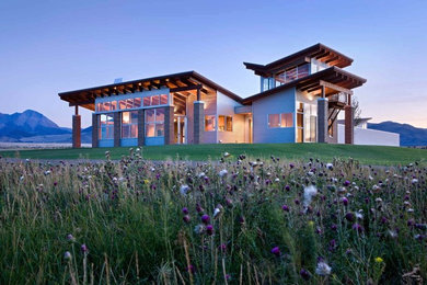 Inspiration for a large rustic metal house exterior remodel in Denver with a shed roof and a metal roof