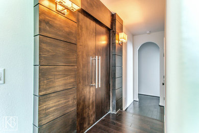 Inspiration for an enclosed carpeted home theater remodel in Houston with brown walls and a projector screen