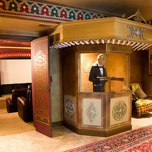 Huge tuscan enclosed limestone floor home theater photo in Sacramento with red walls and a projector screen