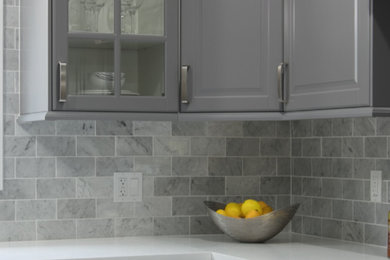 Enclosed kitchen - mid-sized contemporary u-shaped porcelain tile and white floor enclosed kitchen idea in Other with a double-bowl sink, raised-panel cabinets, gray cabinets, quartzite countertops, gray backsplash, marble backsplash and stainless steel appliances