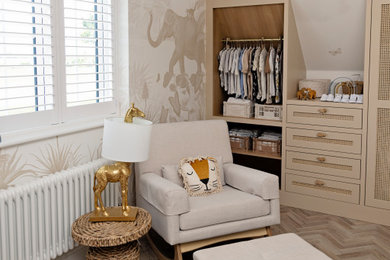 Photo of a large contemporary gender neutral nursery in London with beige walls, medium hardwood flooring, beige floors, a wallpapered ceiling, wallpapered walls and a feature wall.