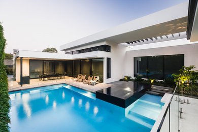 Small modern backyard custom-shaped pool in Melbourne.