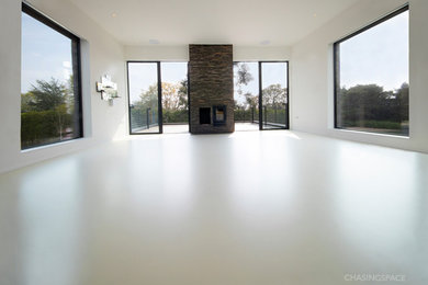 Mid-sized contemporary living room in Hertfordshire with grey floor.