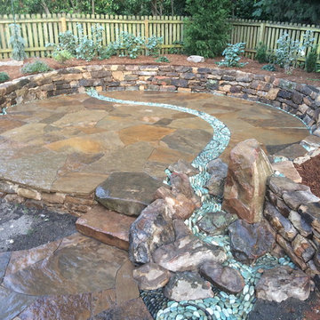 Dry laid patio with pebble stream and waterfall