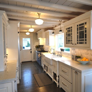 Mid-sized traditional kitchen pantry inspiration - Kitchen pantry - mid-sized traditional galley medium tone wood floor and gray floor kitchen pantry idea in Los Angeles with a farmhouse sink, raised-panel cabinets, white cabinets, quartzite countertops, gray backsplash, marble backsplash, colored appliances and no island