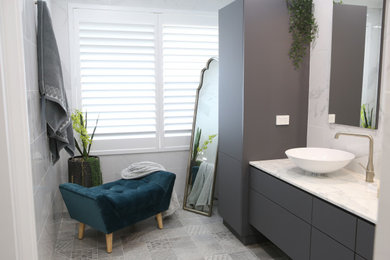 Inspiration for a large contemporary master bathroom in Perth with flat-panel cabinets, grey cabinets, an open shower, a wall-mount toilet, white tile, porcelain tile, porcelain floors, marble benchtops, grey floor, an open shower, white benchtops, an enclosed toilet, a double vanity and a floating vanity.
