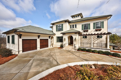 Example of a tuscan stucco exterior home design in Charlotte