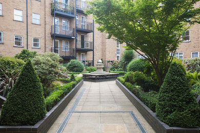 This is an example of a medium sized contemporary brick flat in London with three floors.
