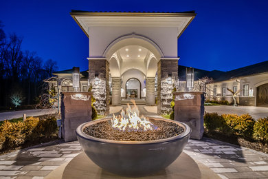 Huge transitional white two-story stucco house exterior photo in Columbus with a hip roof and a shingle roof