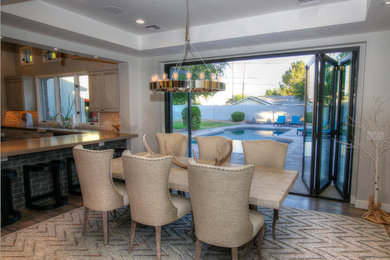 Mid-sized medium tone wood floor and brown floor kitchen/dining room combo photo in Phoenix with gray walls