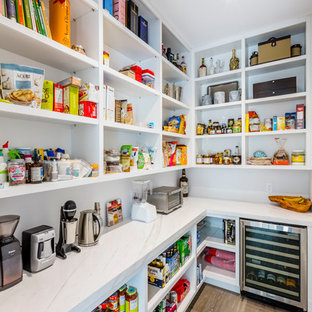 Design ideas for a large contemporary u-shaped kitchen pantry in Toronto with an undermount sink, flat-panel cabinets, white cabinets, marble benchtops, white splashback, stone slab splashback, stainless steel appliances, dark hardwood floors and with island.