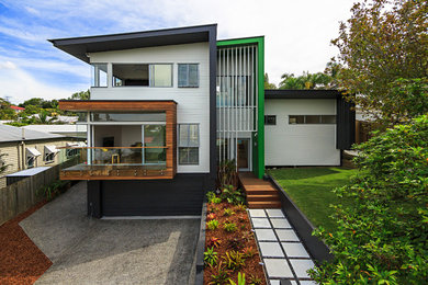 Example of a minimalist two-story exterior home design in Brisbane