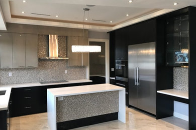 Inspiration for a large contemporary u-shaped marble floor and white floor enclosed kitchen remodel in Vancouver with an undermount sink, flat-panel cabinets, black cabinets, solid surface countertops, gray backsplash, mosaic tile backsplash, stainless steel appliances and an island