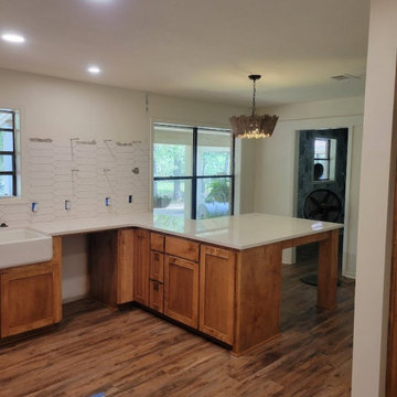 Custom Wood Base Cabinetry with Extended Peninsula & Farmhouse Sink