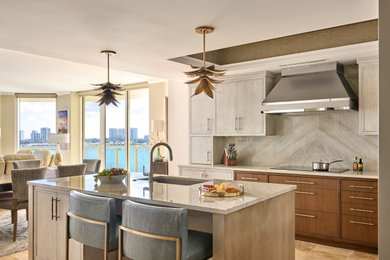 Inspiration for a coastal terra-cotta tile kitchen remodel in Other with flat-panel cabinets, gray backsplash, marble backsplash, paneled appliances, an island and gray countertops