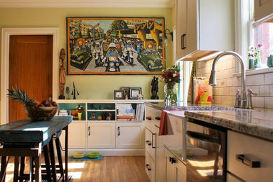Enclosed kitchen - mid-sized transitional galley medium tone wood floor enclosed kitchen idea in Wichita with a farmhouse sink, recessed-panel cabinets, white cabinets, granite countertops, white backsplash, subway tile backsplash, stainless steel appliances, no island and gray countertops