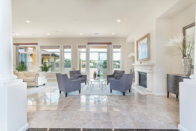 Example of a large tuscan formal and enclosed marble floor living room design in San Diego with beige walls, a standard fireplace and no tv