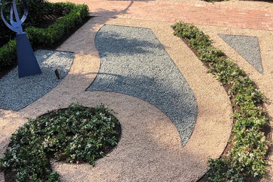 Photo of a small french country rock and full sun courtyard gravel formal garden in Houston.