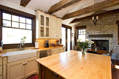Large single-wall dark wood floor eat-in kitchen photo in Denver with a farmhouse sink, louvered cabinets, white cabinets, wood countertops, beige backsplash, ceramic backsplash, stainless steel appliances and an island