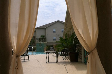Inspiration for a mid-sized coastal concrete patio remodel in Miami with a pergola