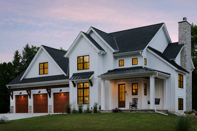 Example of a large farmhouse white two-story concrete fiberboard and board and batten exterior home design in Milwaukee with a mixed material roof and a black roof