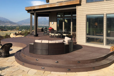 Deck - large contemporary backyard deck idea in Jackson